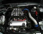 View of engine with cold air intake, Magnecor spark plug wire set, and GReddy radiator cap installed