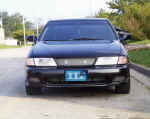 Front view of car with custom grill and PIAA driving lights