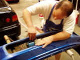 Shawn sanding the front bumper before painting