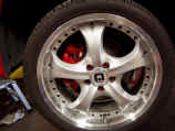 Closeup of Motegi Racing wheel with custom painted brake caliper